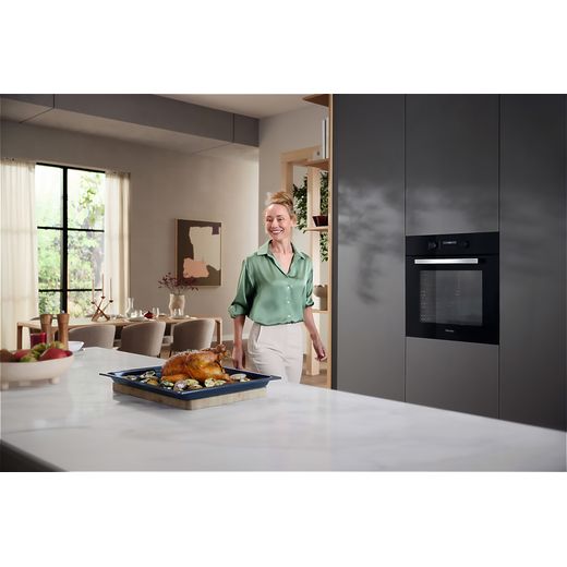Miele 125 Edition Built In Electric Single Oven - Black - Oven in kitchen with women making food